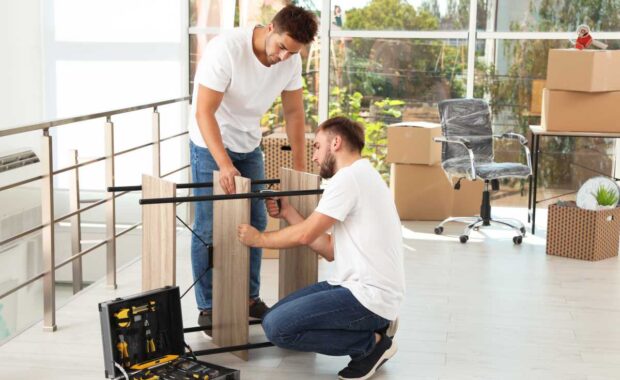 Professional workers disassembling rack in office. Moving service