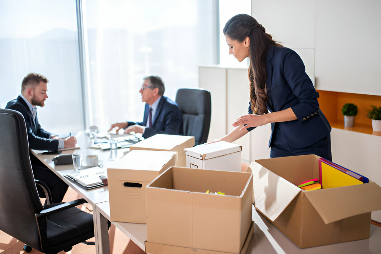 employees packing their office while planning their budget
