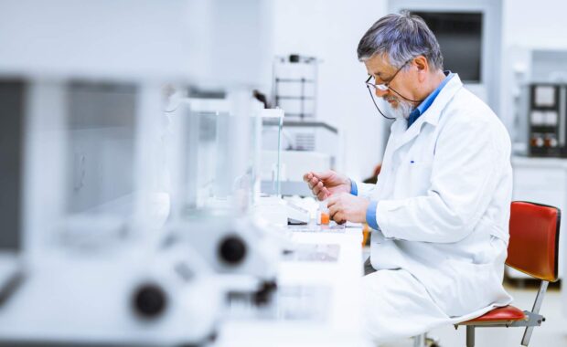 Lab Technician Filling Bottle After A Recent Laboratory Move