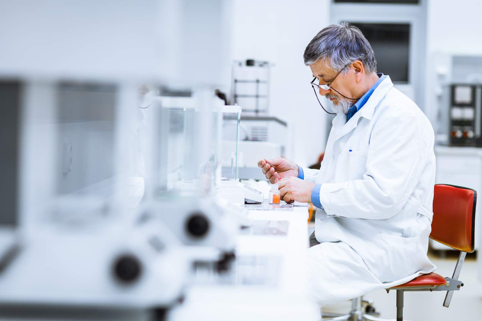 Lab Technician Filling Bottle After A Recent Laboratory Move
