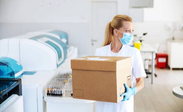 Professional Laboratory Mover Walking With Moving Box
