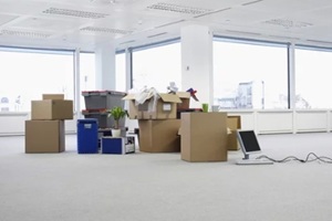 cartons and equipment on floor of empty office space