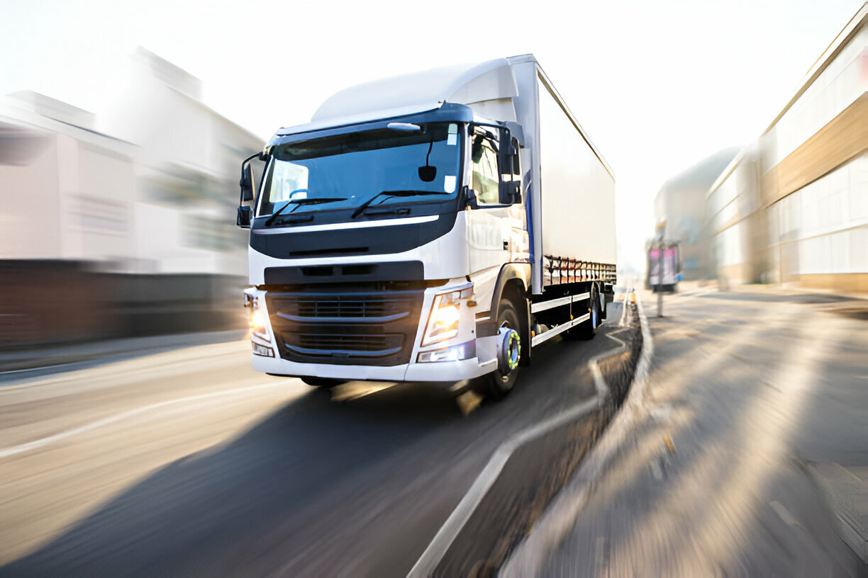commercial moving truck driving down an empty street
