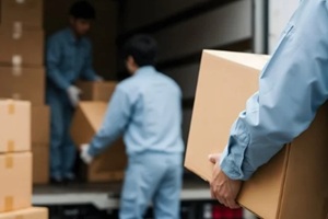 group of government movers unloading or loading boxes from a truck