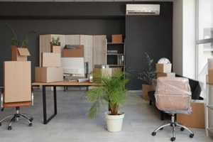 modern workplace with chairs and cardboard boxes in office on moving day
