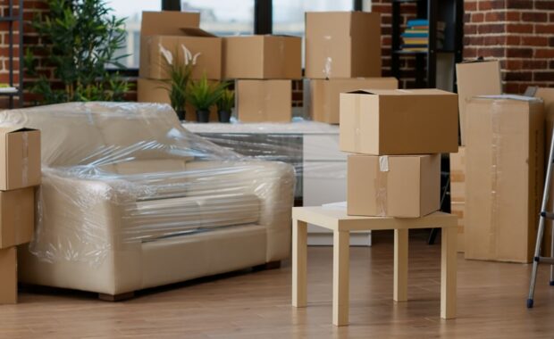 no people in empty living room apartment with carton boxes on stack