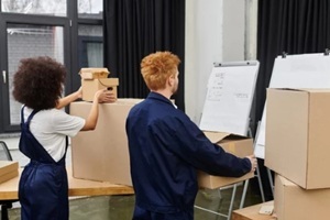 packing up belongings and moving into a modern workspace with enthusiasm and teamwork from government movers