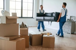 two moving service employees in a room