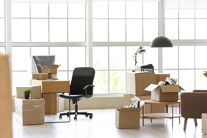 interior of light office with cardboard boxes on moving day