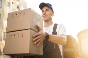 driver in the uniform of the courier company fast delivery of goods to the house