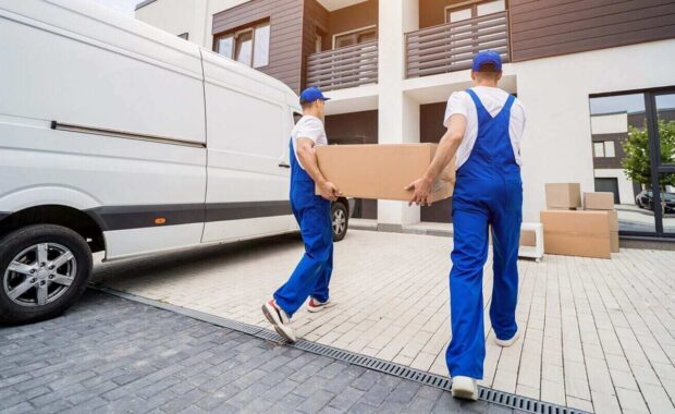 removal company workers unloading boxes and furniture from minibus