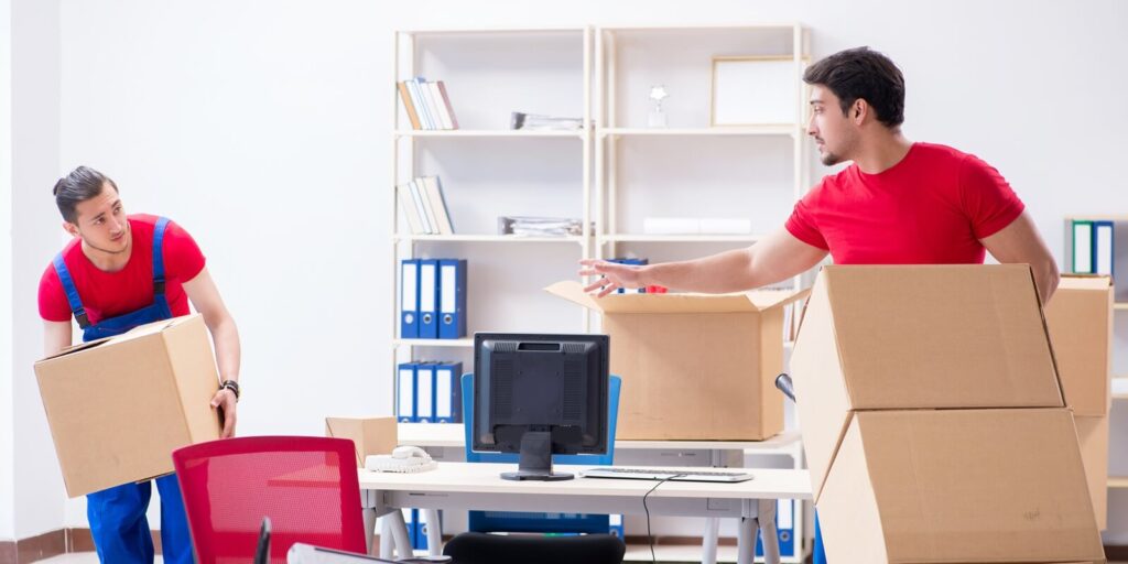 two contractor employees moving personal belongings