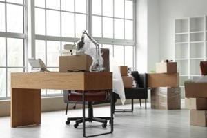 workplace with cardboard boxes in office on moving day