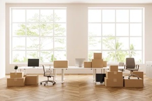office interior with armchair and pc computer, moving boxes, panoramic window