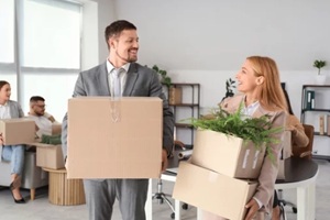 a two person with boxes in office on moving day