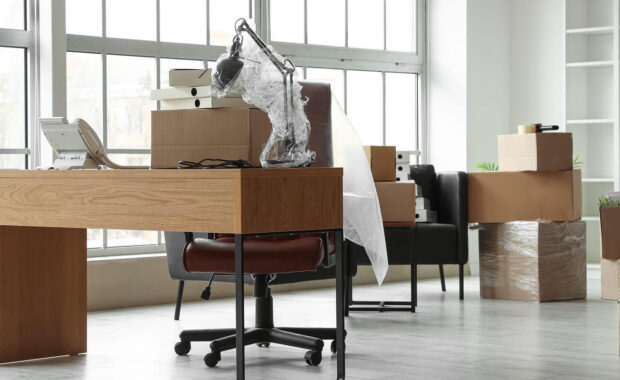 workplace with cardboard boxes in office on moving day