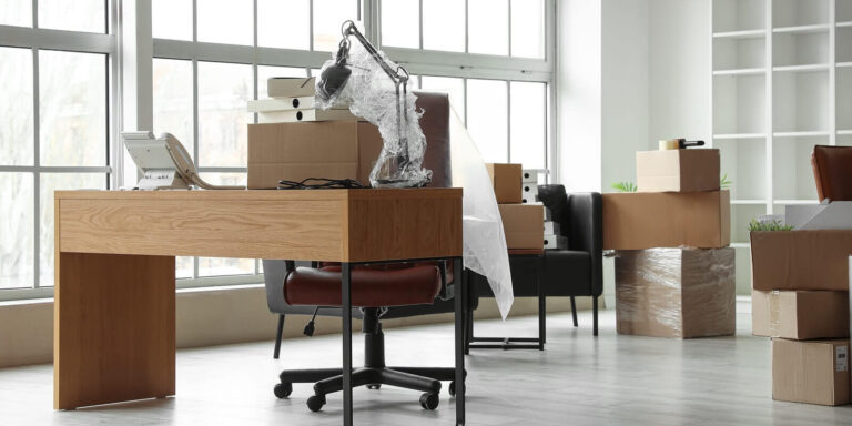 workplace with cardboard boxes in office on moving day