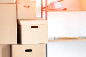 cardboard boxes stack on metal shelves