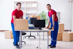 two contractor employees moving personal belongings